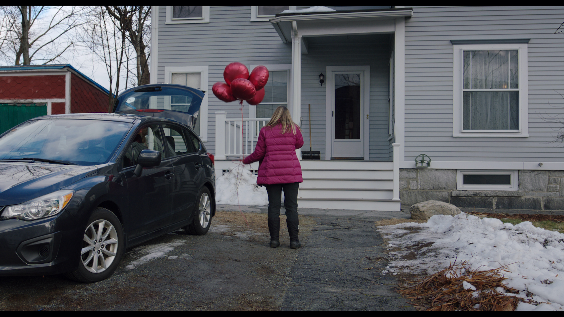 Tiff holding balloons.